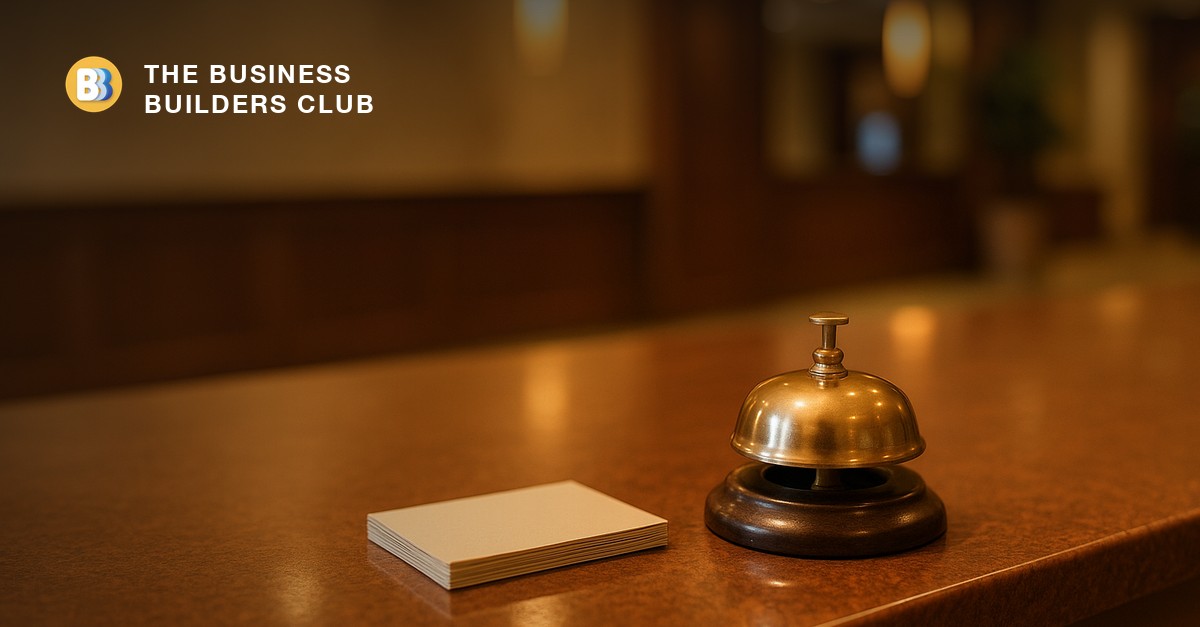 A hotel reception desk with a brass service bell, standing in for a welcoming customer onboarding