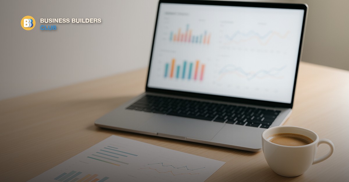 A clean dashboard on a laptop screen showing business metrics in a bright modern office