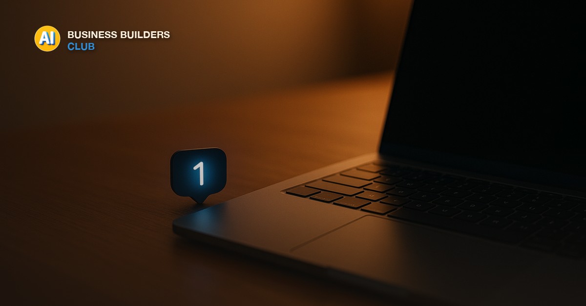 A single dark blue notification badge glowing beside an open laptop keyboard on a wooden desk, soft evening office light